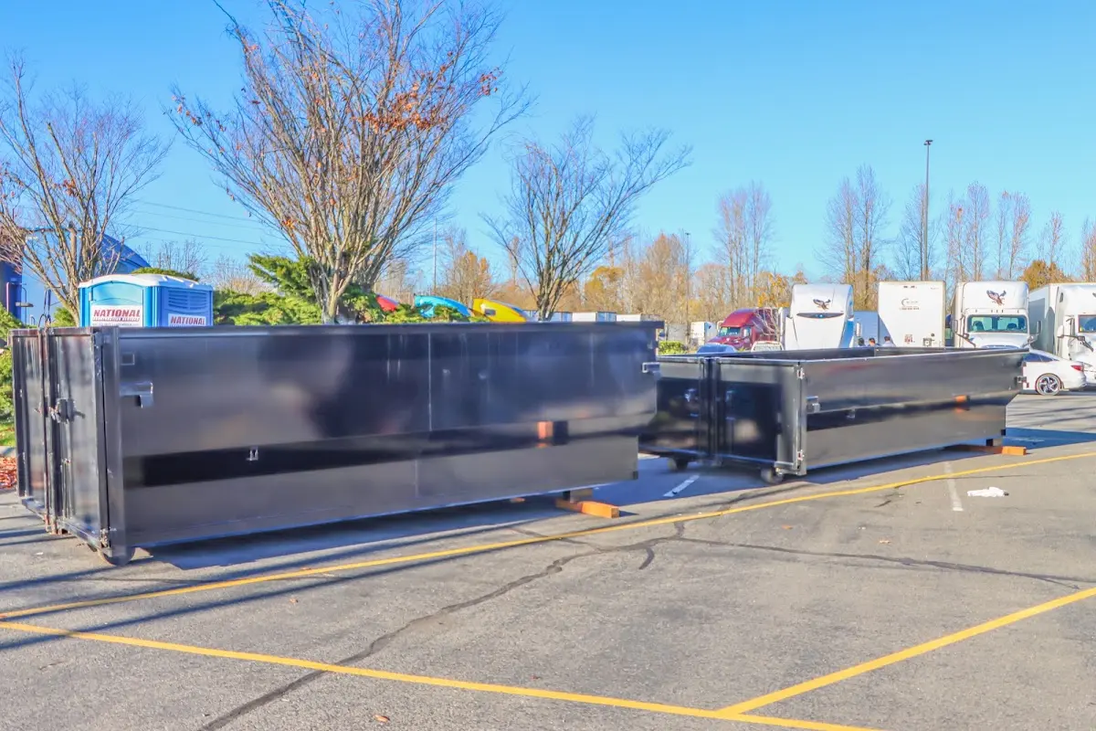 Professional dumpster rental service with roll-off container on residential driveway in Centerville